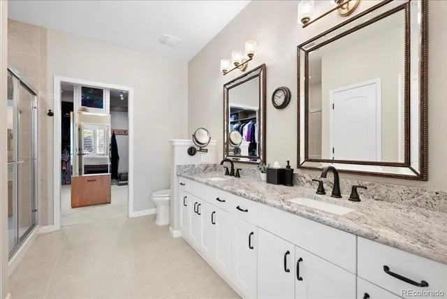 a bathroom with double vanity sinks and a mirror