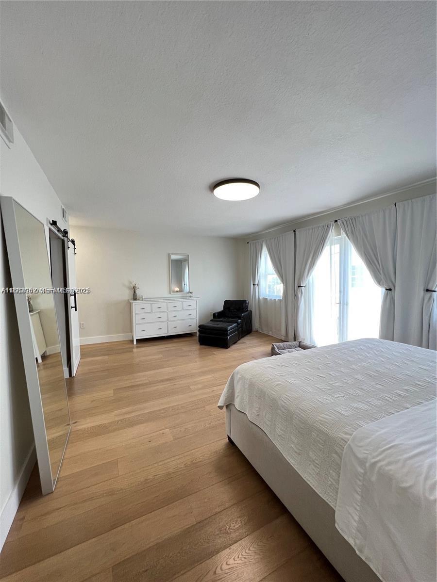 1043 Southwest 9th Court, Unit F1 Miami, FL 33130 - Photo 14 of 27 a bedroom with a bed and window