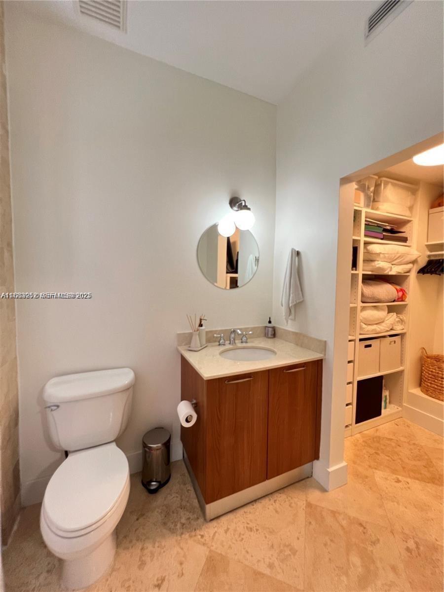 1043 Southwest 9th Court, Unit F1 Miami, FL 33130 - Photo 16 of 27 a bathroom with a toilet sink and mirror