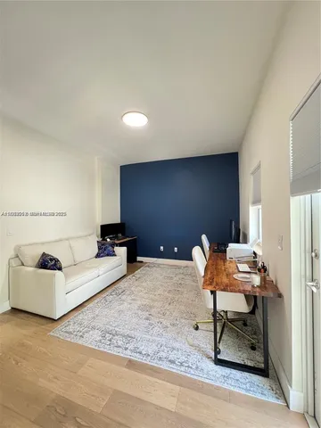 a living room with furniture and a rug