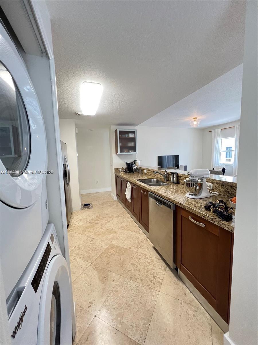 1043 Southwest 9th Court, Unit F1 Miami, FL 33130 - Photo 19 of 27 a large kitchen with stainless steel appliances granite countertop a stove and a sink