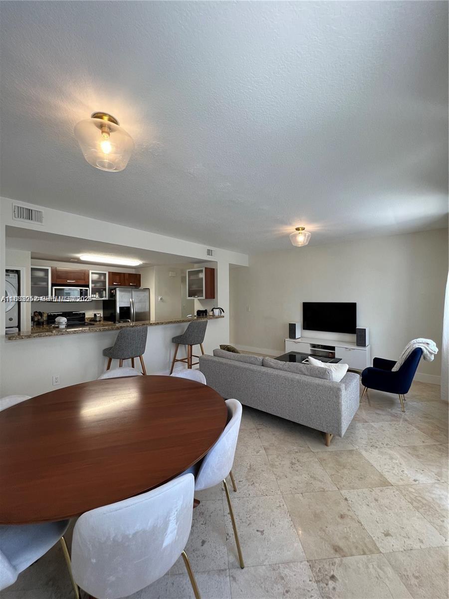 1043 Southwest 9th Court, Unit F1 Miami, FL 33130 - Photo 20 of 27 a living room with furniture and a flat screen tv