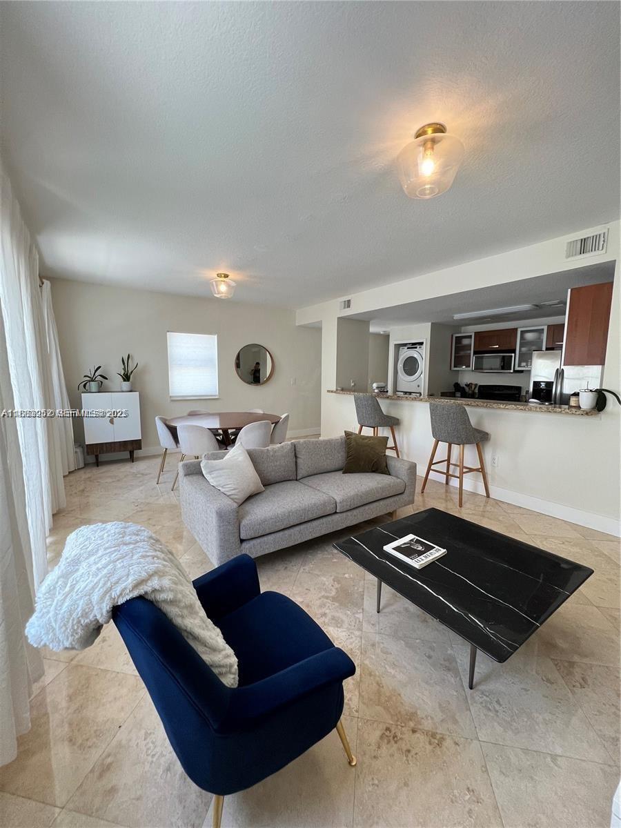 1043 Southwest 9th Court, Unit F1 Miami, FL 33130 - Photo 21 of 27 a living room with furniture rug and kitchen view