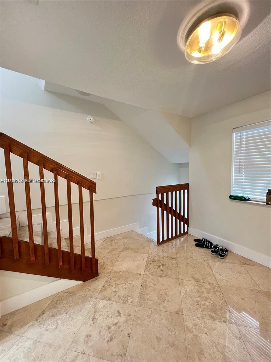 1043 Southwest 9th Court, Unit F1 Miami, FL 33130 - Photo 7 of 27 a view of staircase with white walls
