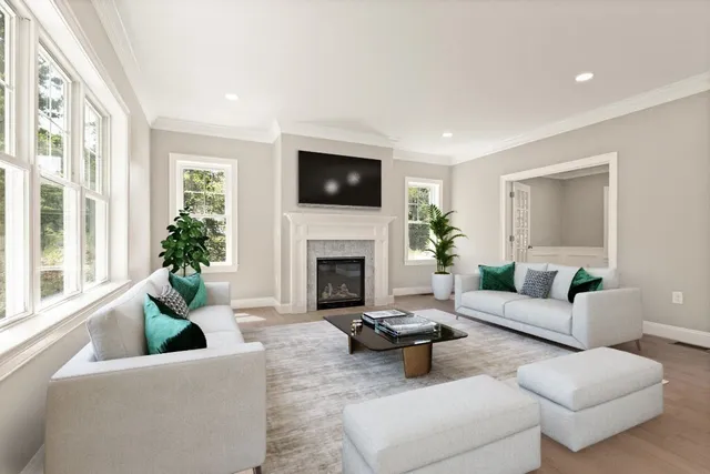 a living room with furniture a flat screen tv and a fireplace