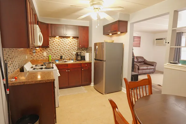 a kitchen with refrigerator and sink