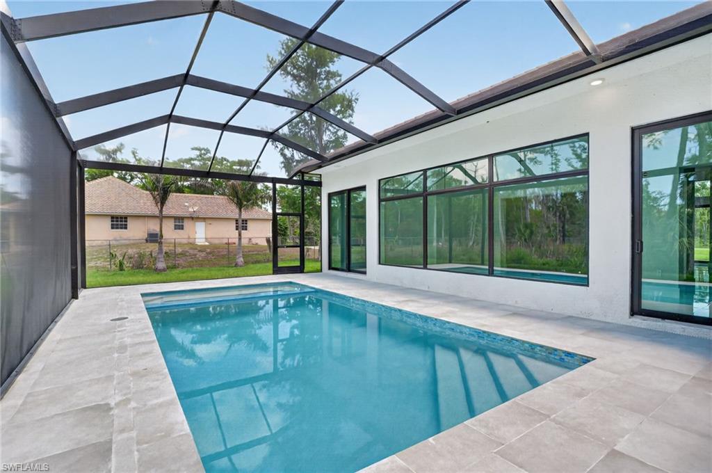 563 15th Street Northwest Naples, FL 34120 - Photo 16 of 22 a view of swimming pool with a patio