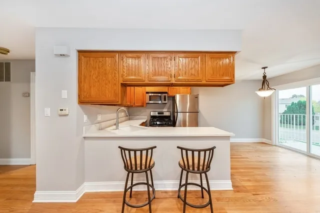 a kitchen with a table chairs and a wooden floor