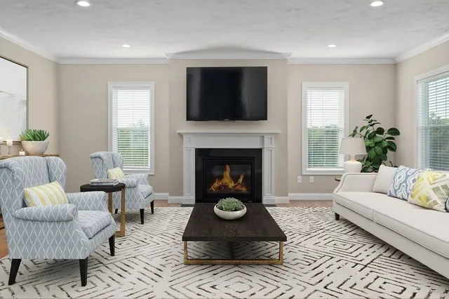 a living room with furniture a flat screen tv and a fireplace