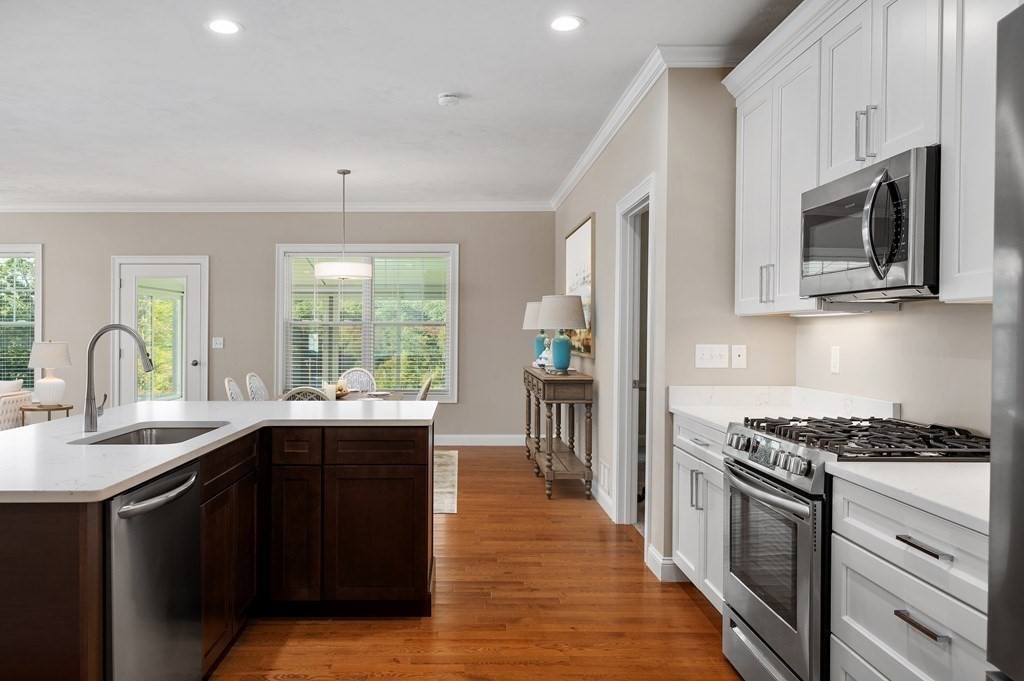 159 Rolling Rdg Drive, Unit 85 Northbridge, MA 01588 - Photo 11 of 25 a kitchen with stainless steel appliances granite countertop a stove top oven a sink dishwasher and cabinets with wooden floor