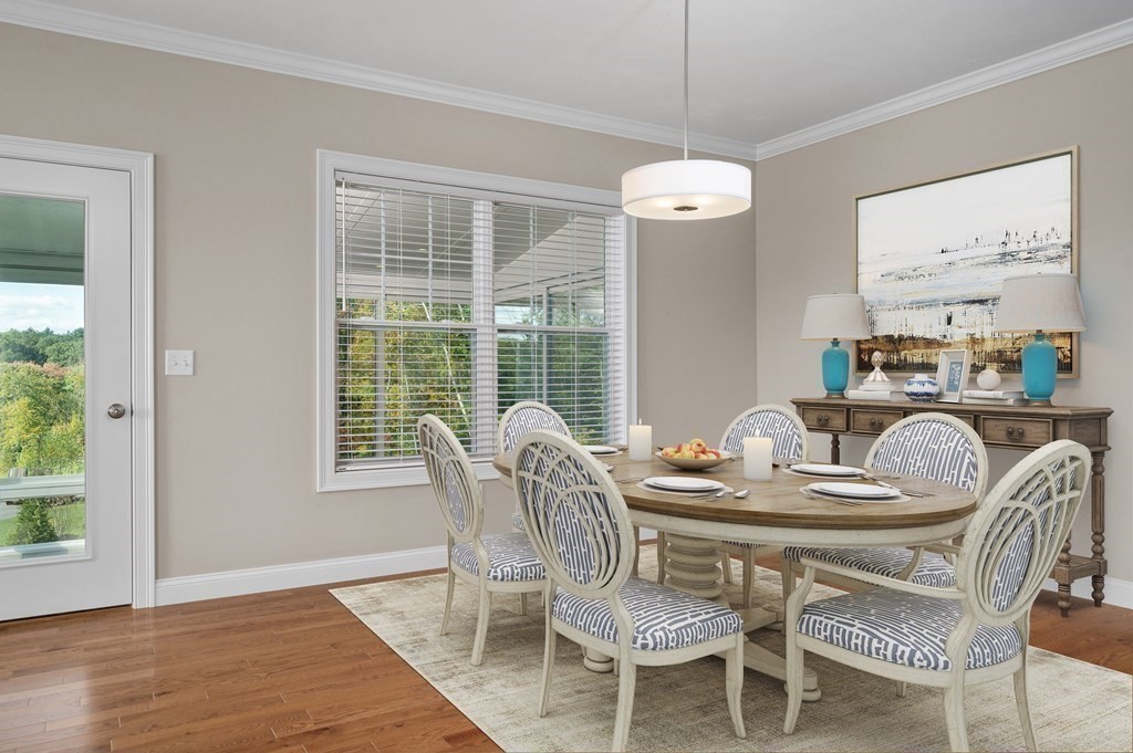 159 Rolling Rdg Drive, Unit 85 Northbridge, MA 01588 - Photo 12 of 25 a dining room with furniture a large window and wooden floor