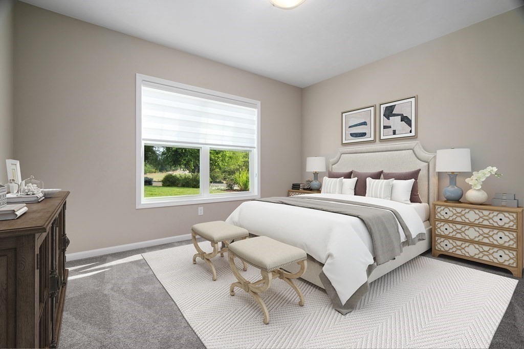 159 Rolling Rdg Drive, Unit 85 Northbridge, MA 01588 - Photo 17 of 25 a bedroom with a bed and a table