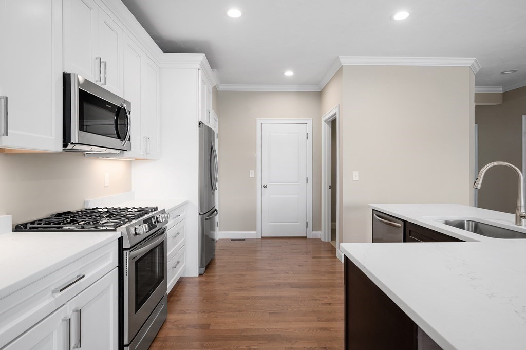 159 Rolling Rdg Drive, Unit 85 Northbridge, MA 01588 - Photo 10 of 25 a kitchen with stainless steel appliances a stove microwave and sink