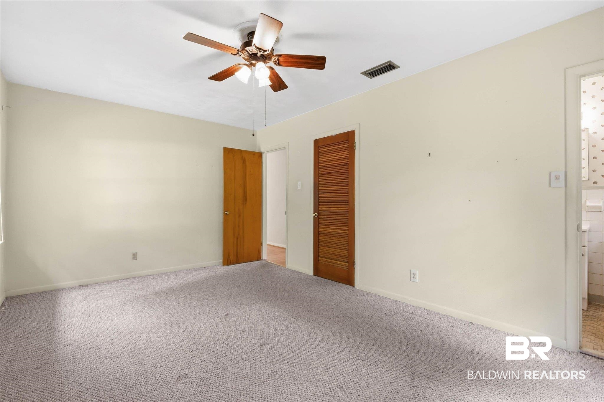 1182 Ginger Drive Mobile, AL 36693 - Photo 19 of 37 Carpeted room with a ceiling fan, light-colored walls, and two wood-paneled doors