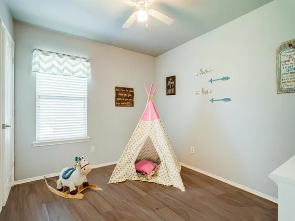 a view of a room with wooden floor and window
