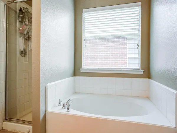 a white bath tub sitting next to a window
