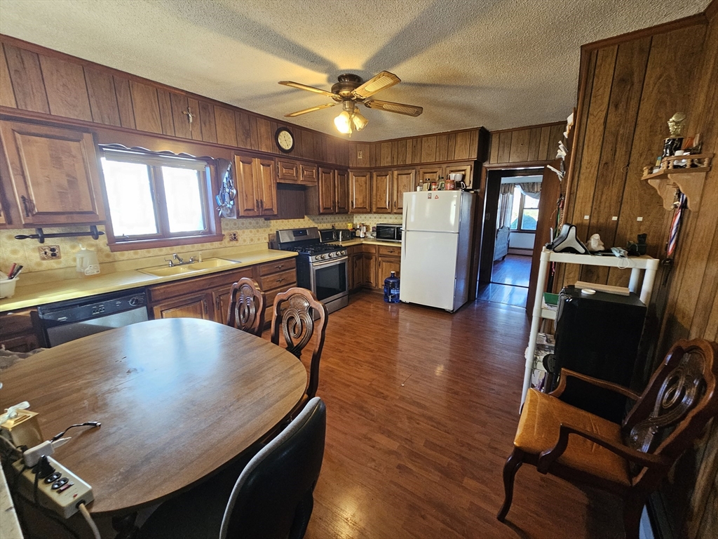 65 Beattie Street Fall River, MA 02723 - Photo 4 of 10 a large kitchen with a table chairs refrigerator and window