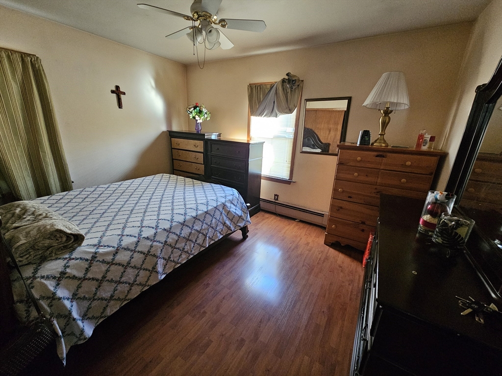 65 Beattie Street Fall River, MA 02723 - Photo 6 of 10 a bedroom with bed and wooden floor