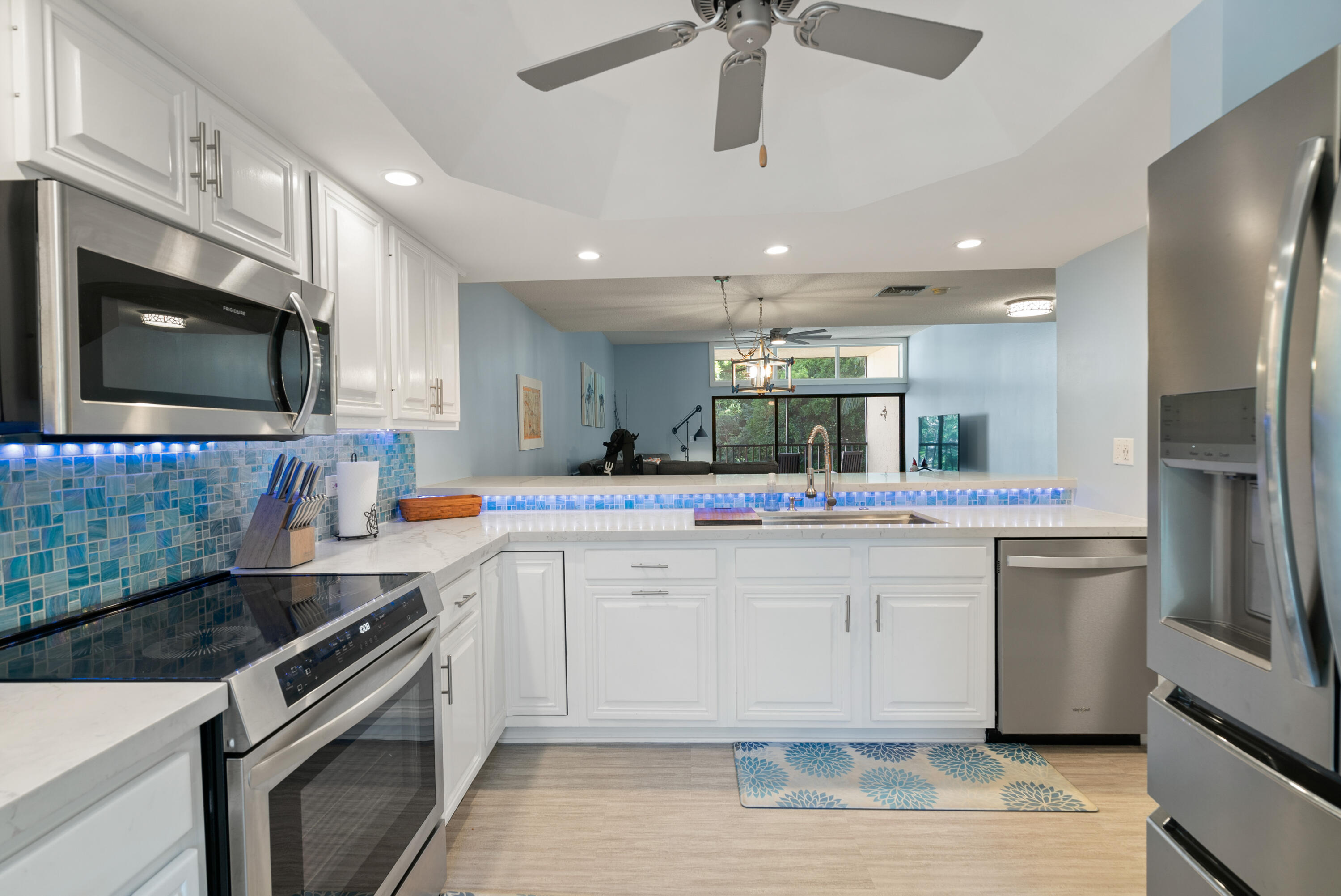 94220 Overseas Highway, Unit 5E Tavernier, FL 33037 - Photo 20 of 77 a kitchen with stainless steel appliances a sink stove and refrigerator