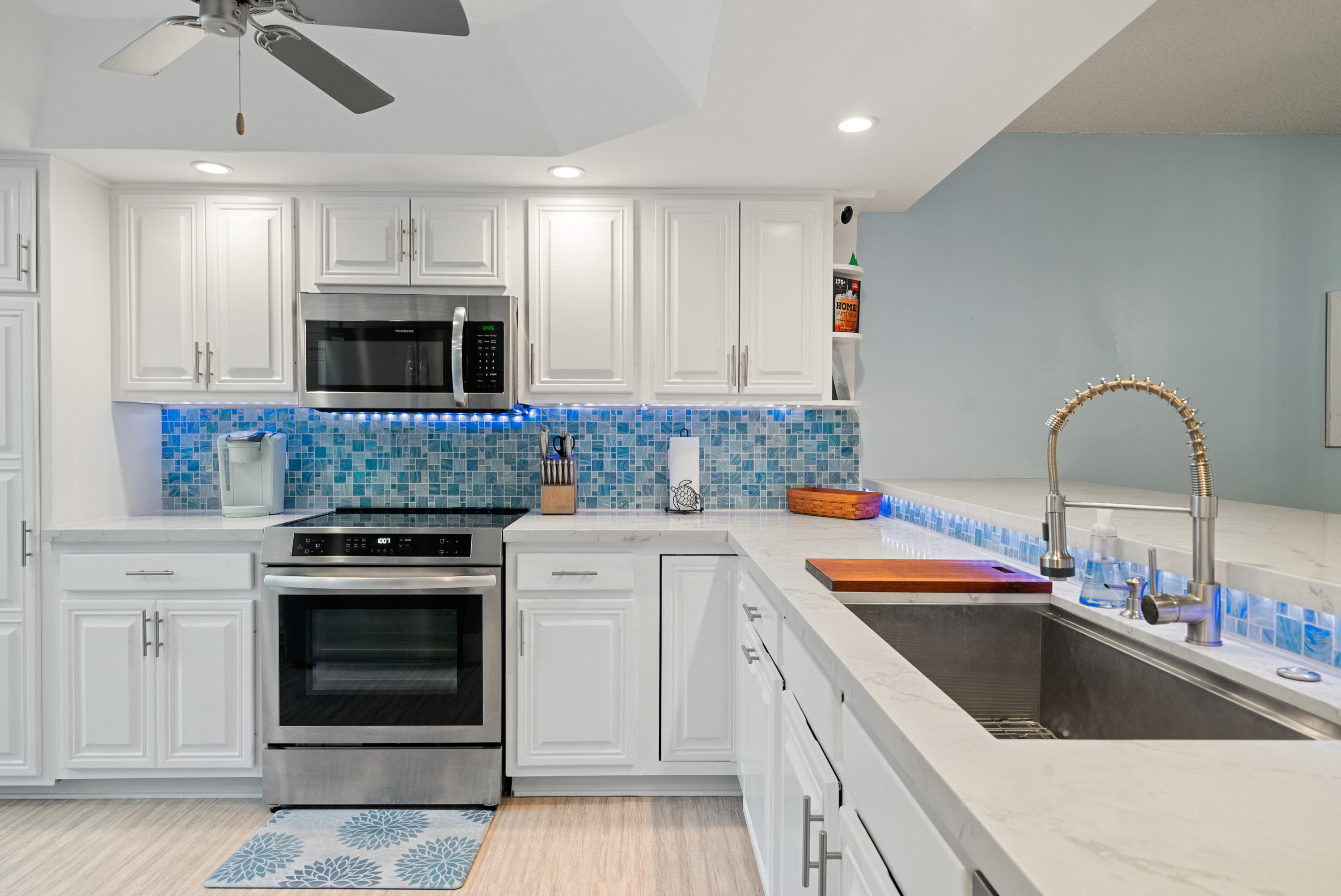 94220 Overseas Highway, Unit 5E Tavernier, FL 33037 - Photo 21 of 77 a kitchen with stainless steel appliances granite countertop a sink and cabinets