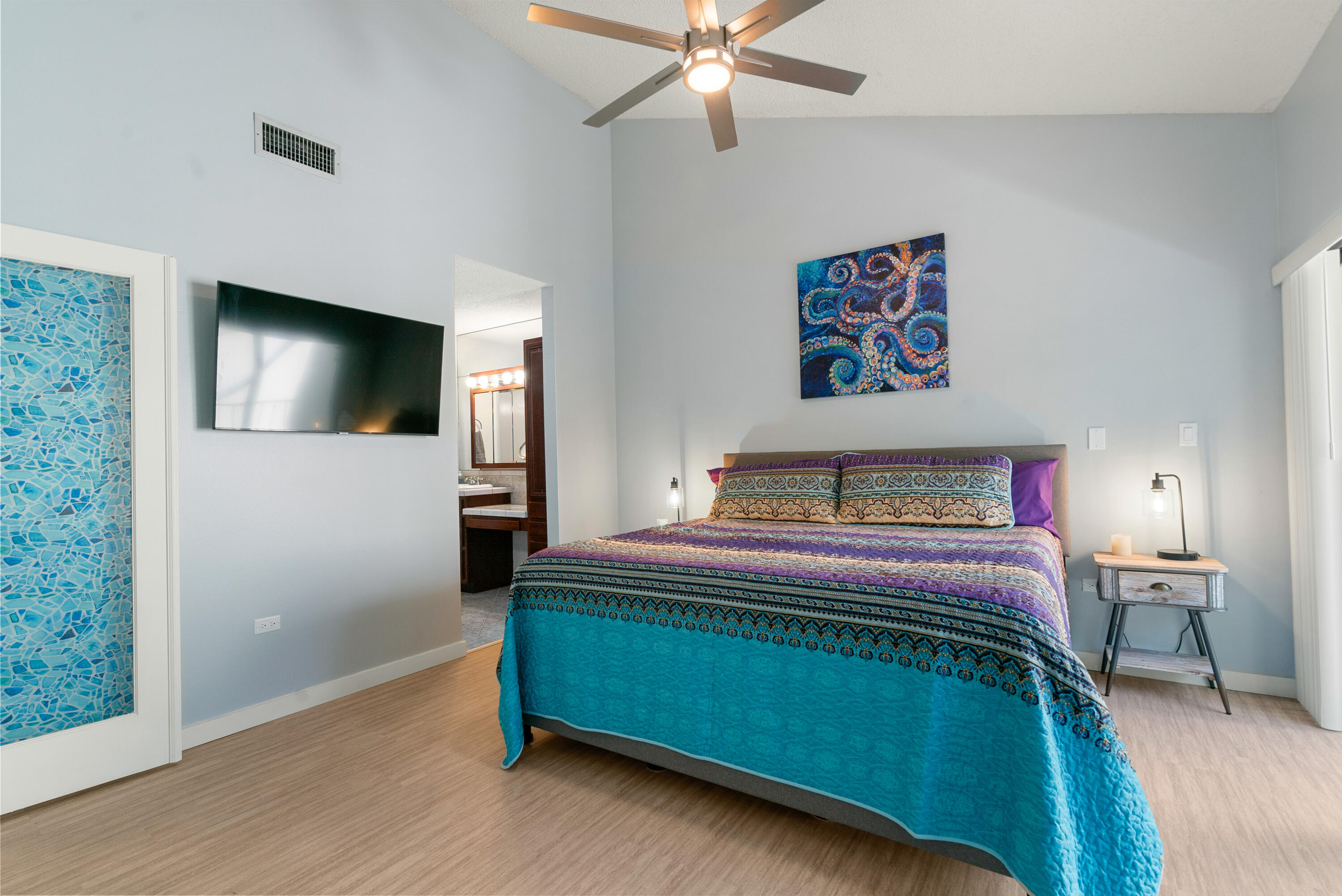 94220 Overseas Highway, Unit 5E Tavernier, FL 33037 - Photo 26 of 77 a bedroom with a bed and a flat screen tv