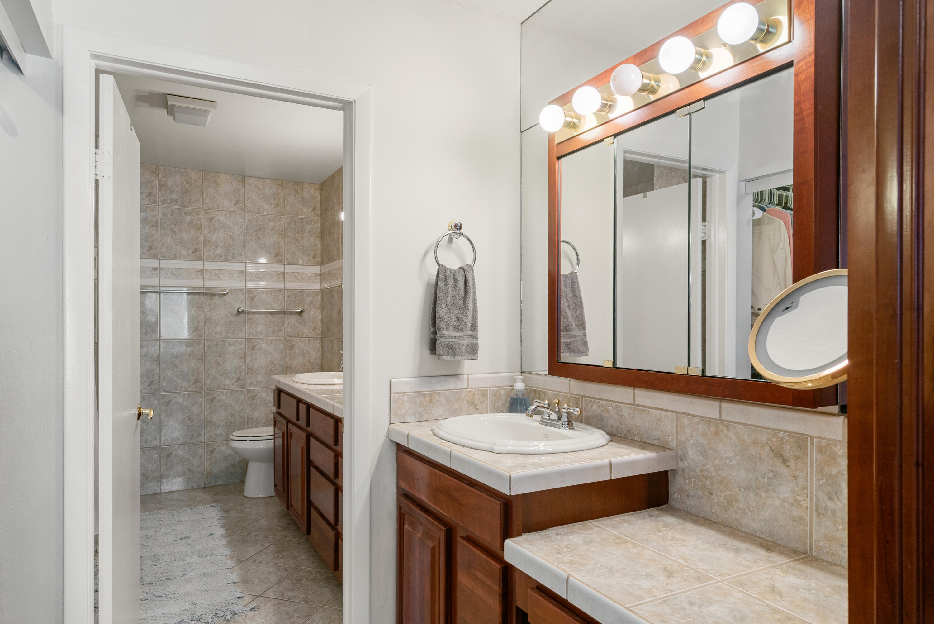 94220 Overseas Highway, Unit 5E Tavernier, FL 33037 - Photo 27 of 77 a bathroom with a sink a toilet and shower