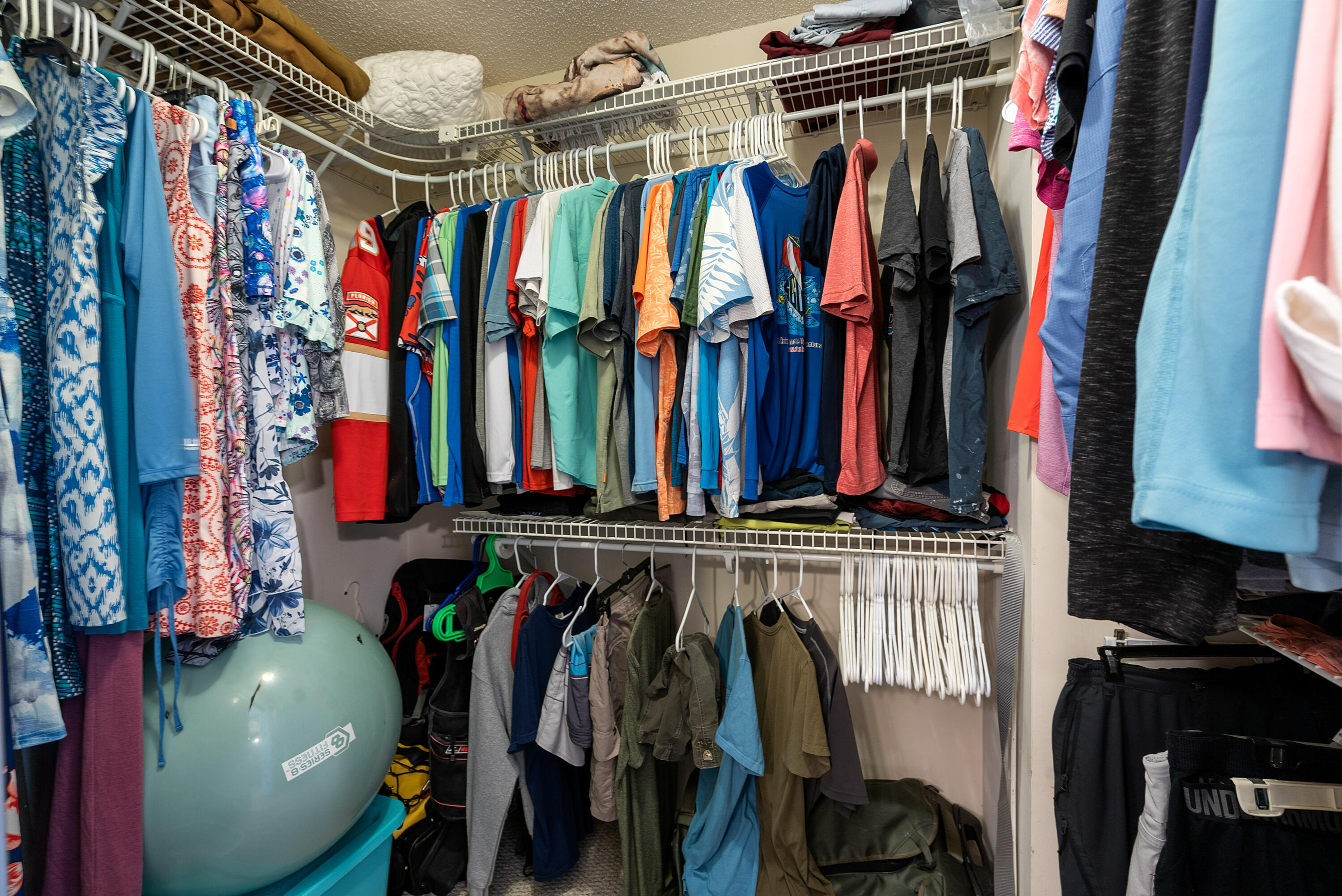 94220 Overseas Highway, Unit 5E Tavernier, FL 33037 - Photo 29 of 77 a view of walk in closet with clothes and shoes