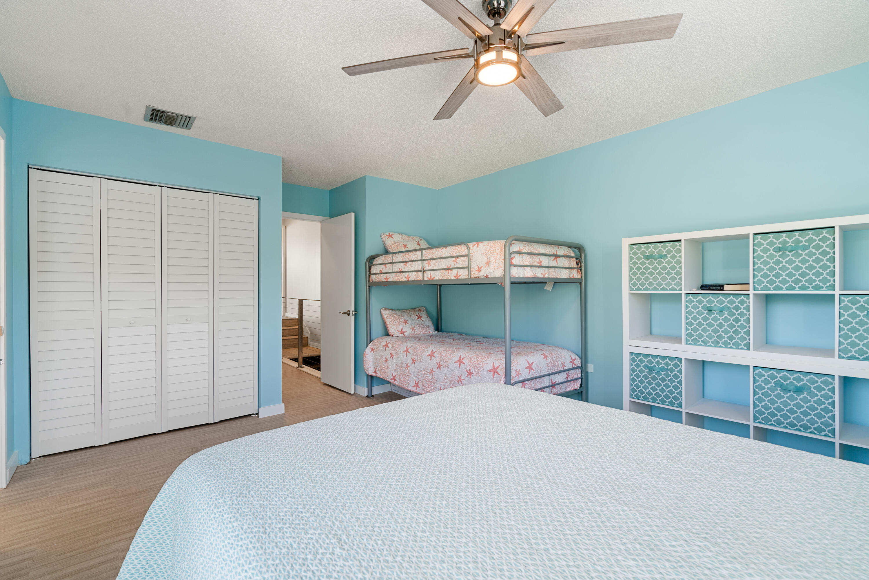 94220 Overseas Highway, Unit 5E Tavernier, FL 33037 - Photo 34 of 77 a bedroom with a bed and a chandelier