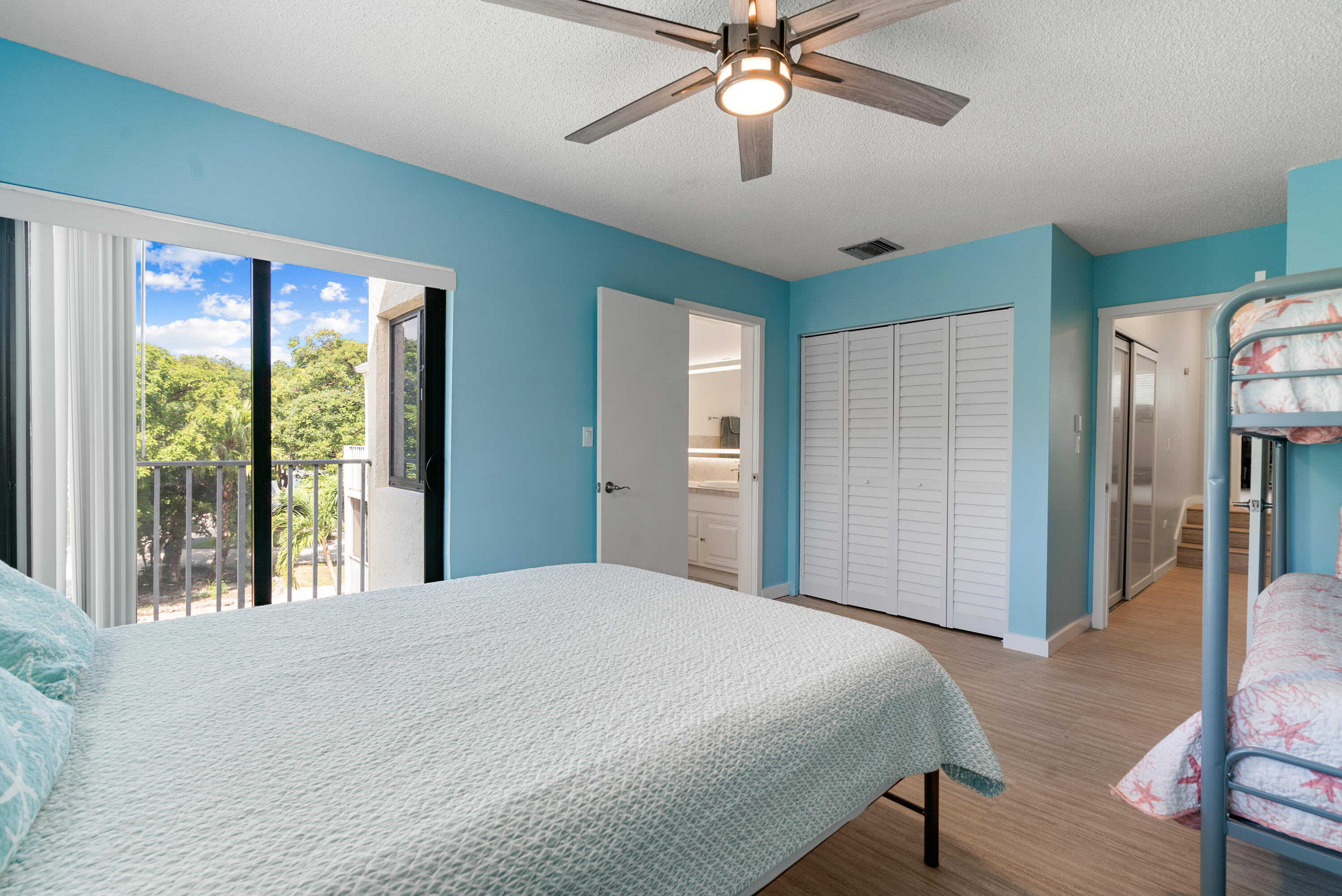 94220 Overseas Highway, Unit 5E Tavernier, FL 33037 - Photo 36 of 77 a bedroom with a large bed and a chandelier