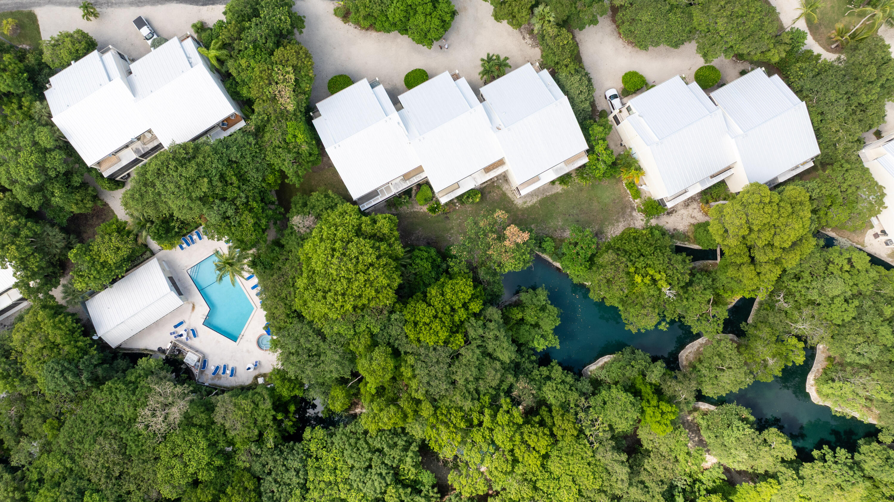 94220 Overseas Highway, Unit 5E Tavernier, FL 33037 - Photo 65 of 77 an aerial view of a house with a yard and large trees
