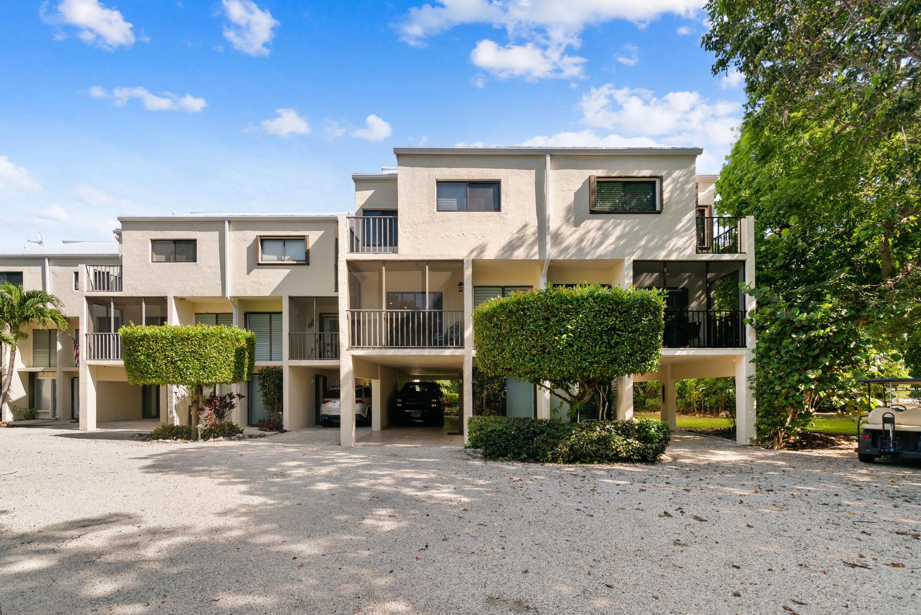 94220 Overseas Highway, Unit 5E Tavernier, FL 33037 - Photo 74 of 77 a front view of a house with garden