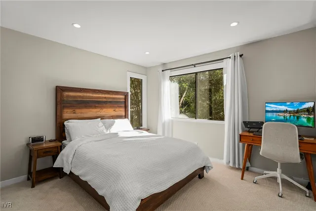 a bedroom with a bed chair and a window