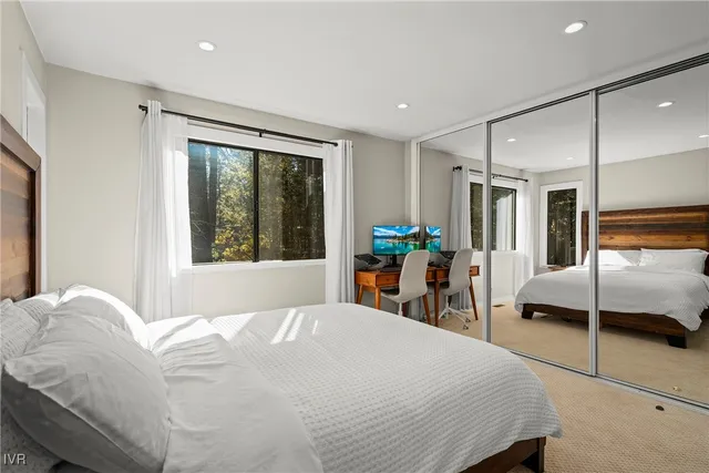 a bedroom with a bed and a large window