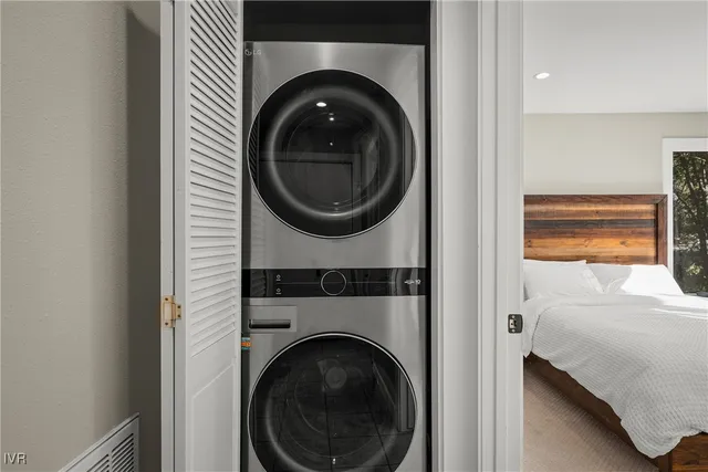 a close up view of a bedroom with washer and dryer