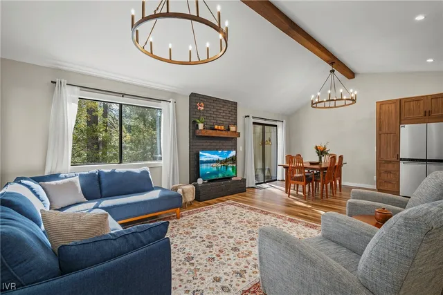 a living room with furniture a window and a flat screen tv