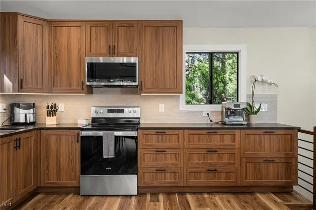 a kitchen with granite countertop a stove and a sink