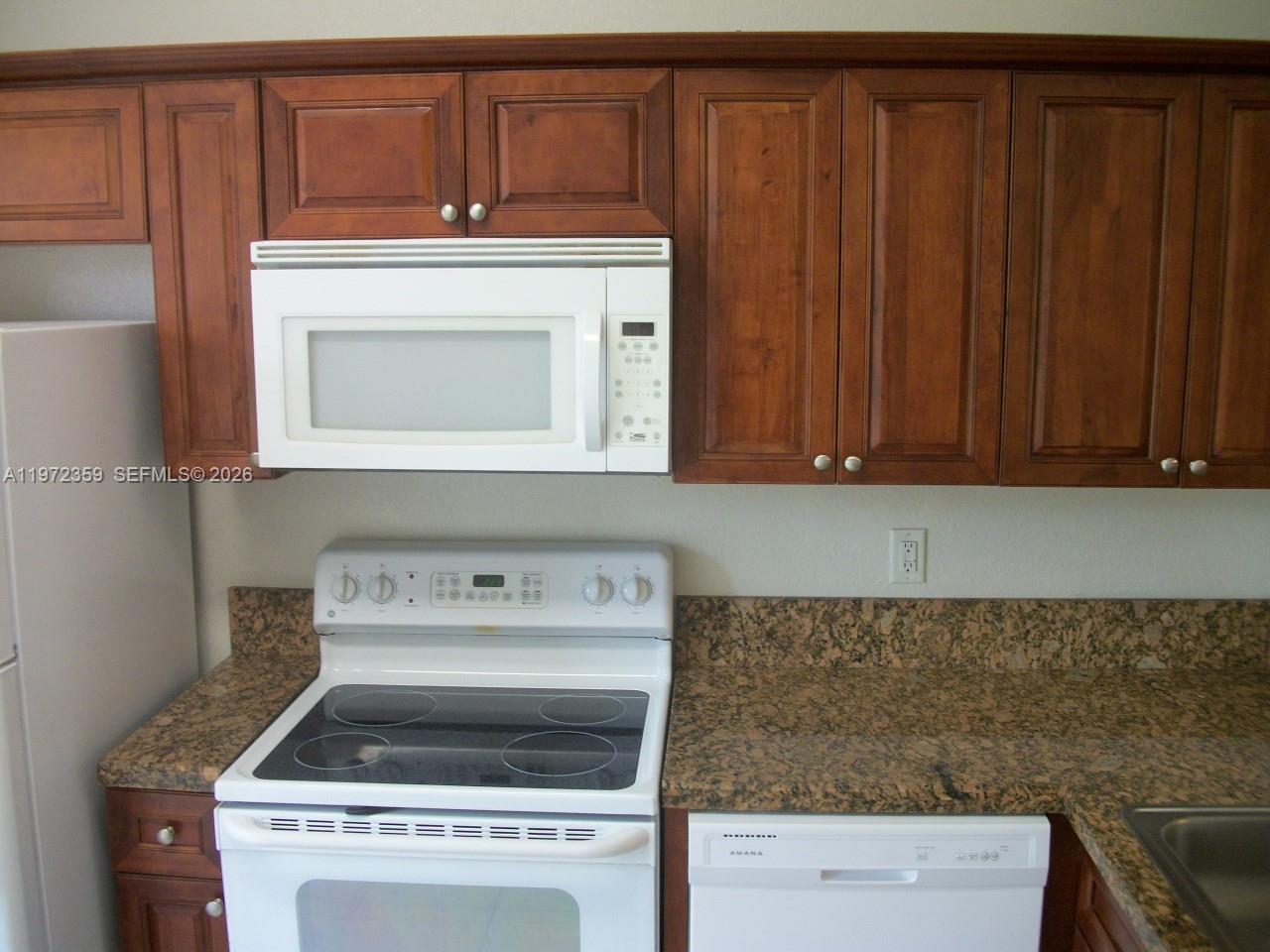 1596 Southwest 2nd Street Homestead, FL 33030 - Photo 13 of 42 a kitchen with a stove and a microwave