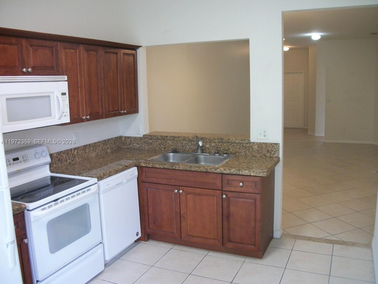 1596 Southwest 2nd Street Homestead, FL 33030 - Photo 14 of 42 a kitchen with a stove and a sink