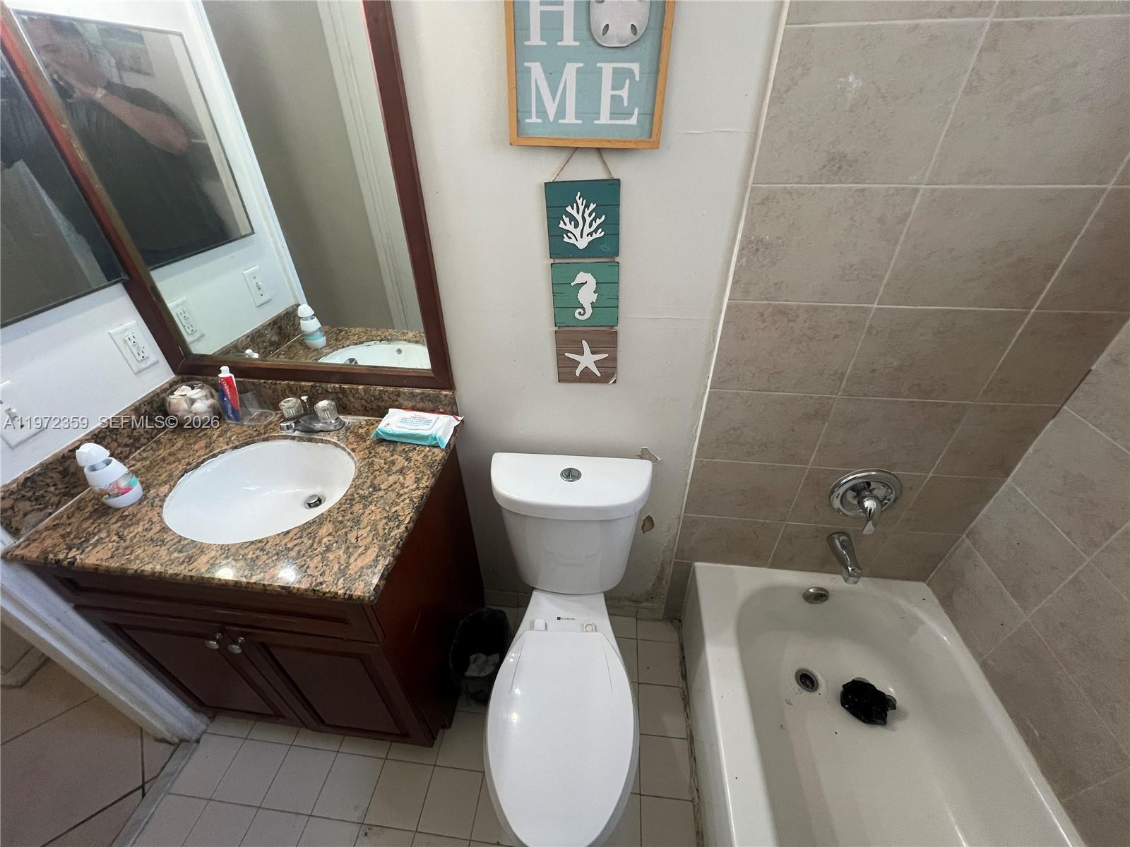 1596 Southwest 2nd Street Homestead, FL 33030 - Photo 21 of 42 a bathroom with a granite countertop sink toilet and mirror