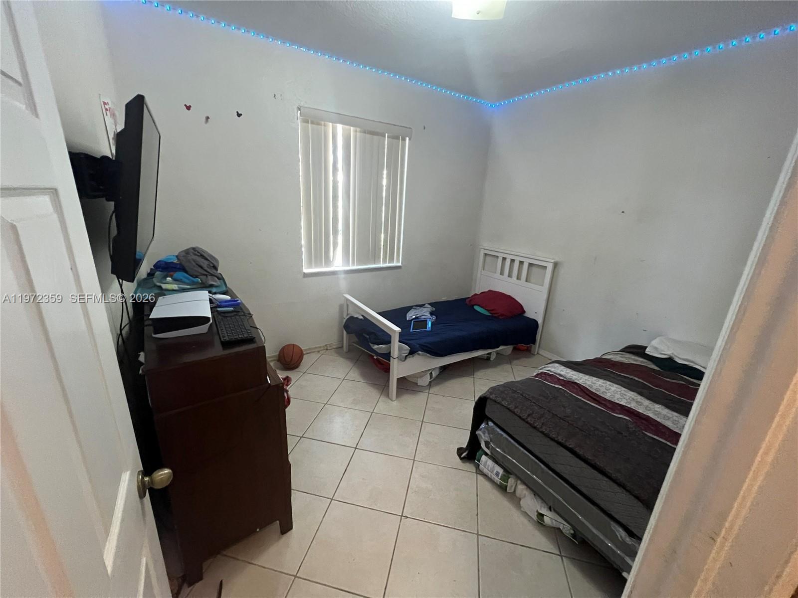 1596 Southwest 2nd Street Homestead, FL 33030 - Photo 23 of 42 a bedroom with furniture and a window