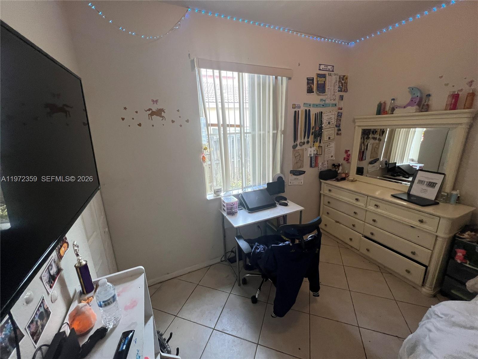 1596 Southwest 2nd Street Homestead, FL 33030 - Photo 30 of 42 a view of a workspace with furniture and a window