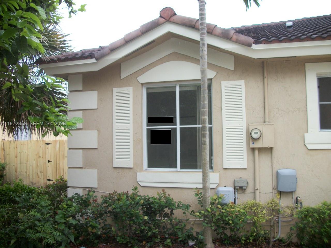 1596 Southwest 2nd Street Homestead, FL 33030 - Photo 3 of 42 a front view of a house with plants