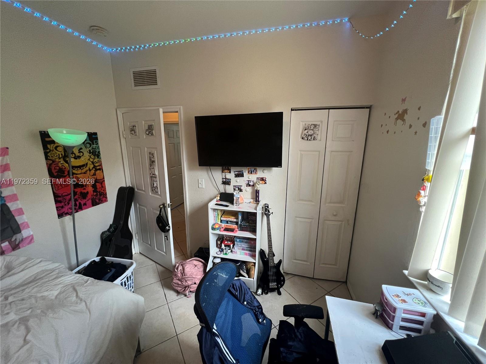 1596 Southwest 2nd Street Homestead, FL 33030 - Photo 31 of 42 a living room with furniture and a flat screen tv
