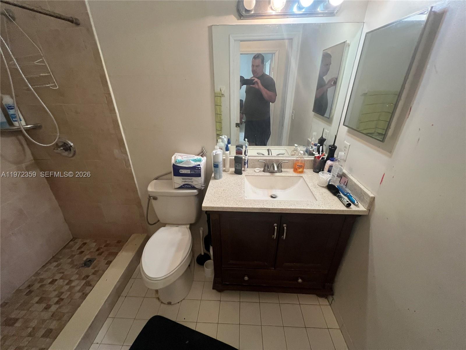 1596 Southwest 2nd Street Homestead, FL 33030 - Photo 33 of 42 a bathroom with a sink toilet and mirror