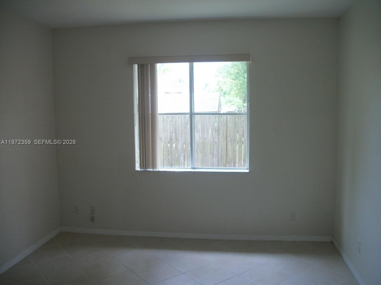 1596 Southwest 2nd Street Homestead, FL 33030 - Photo 38 of 42 an empty room with a window