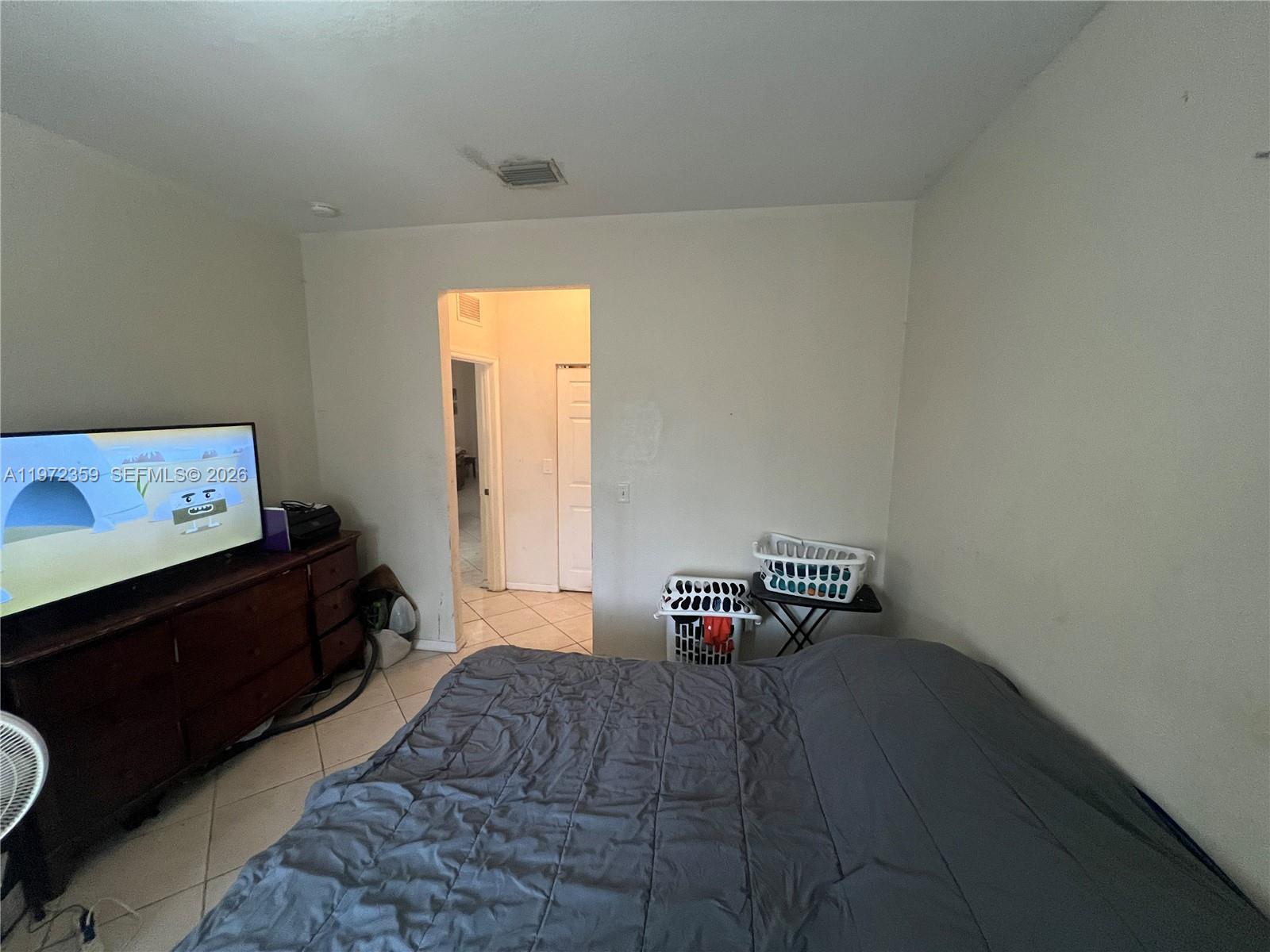 1596 Southwest 2nd Street Homestead, FL 33030 - Photo 41 of 42 a bedroom with furniture and window