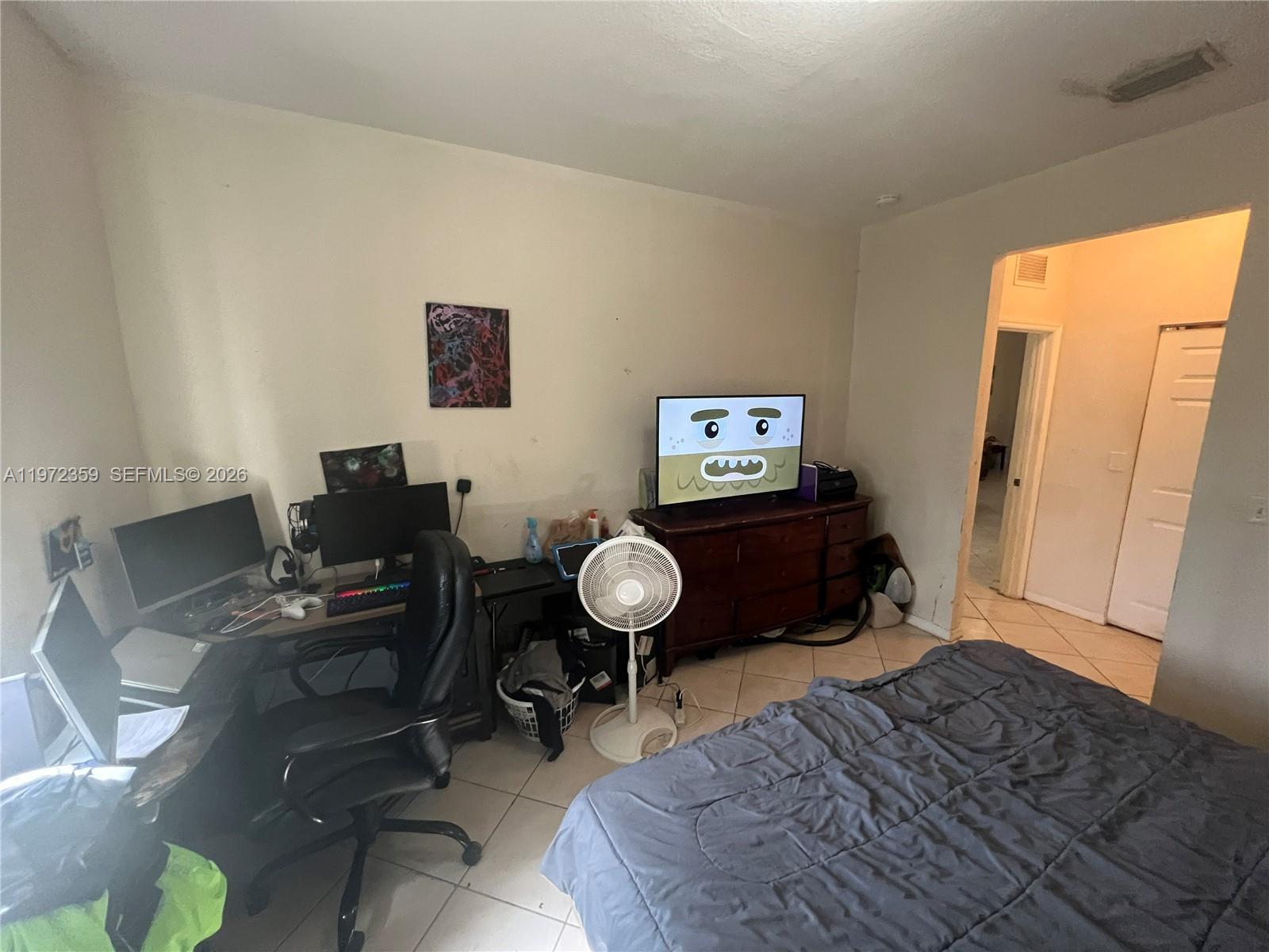 1596 Southwest 2nd Street Homestead, FL 33030 - Photo 42 of 42 a bed room with a bed mirror and a window