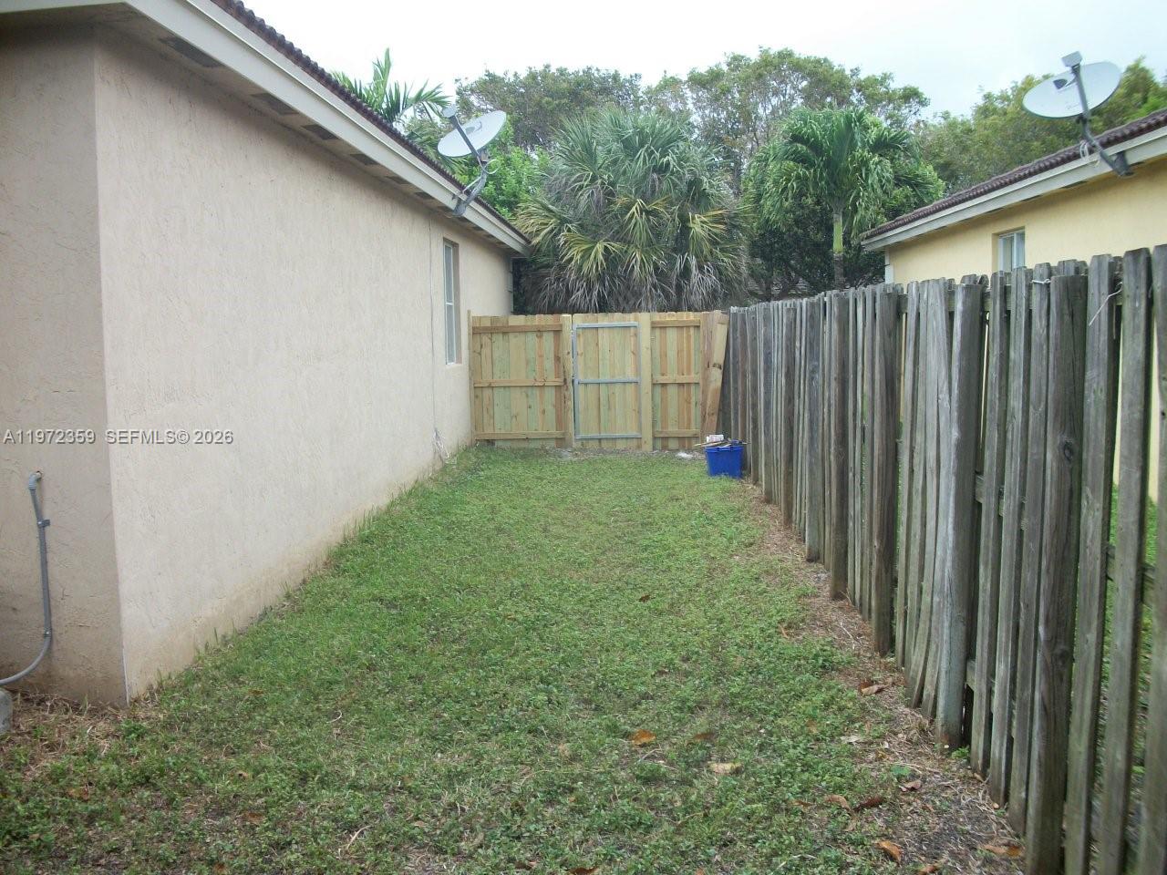 1596 Southwest 2nd Street Homestead, FL 33030 - Photo 6 of 42 a view of backyard with tub and trees