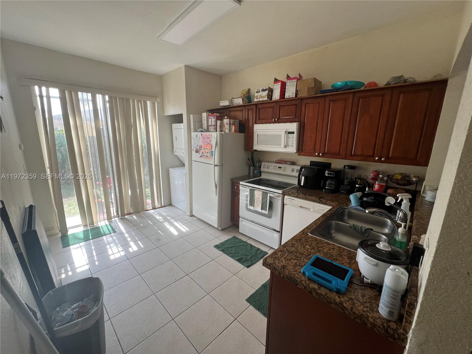 1596 Southwest 2nd Street Homestead, FL 33030 - Photo 10 of 42 a view of kitchen with refrigerator stove and window
