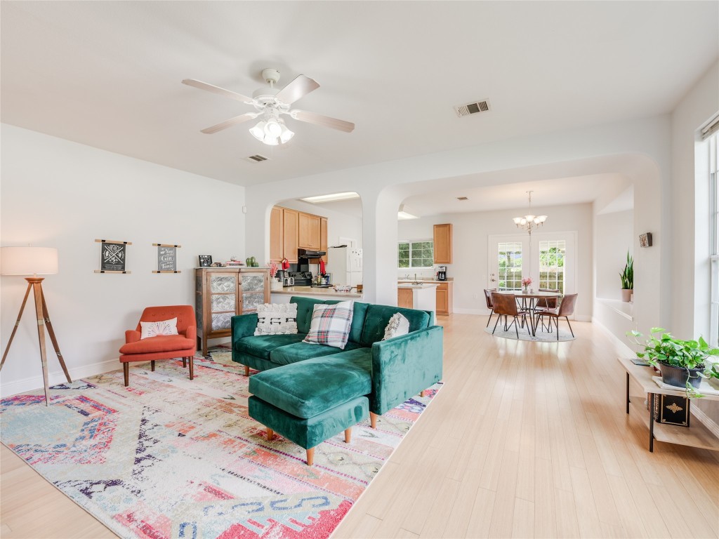 a living room with furniture and a chandelier